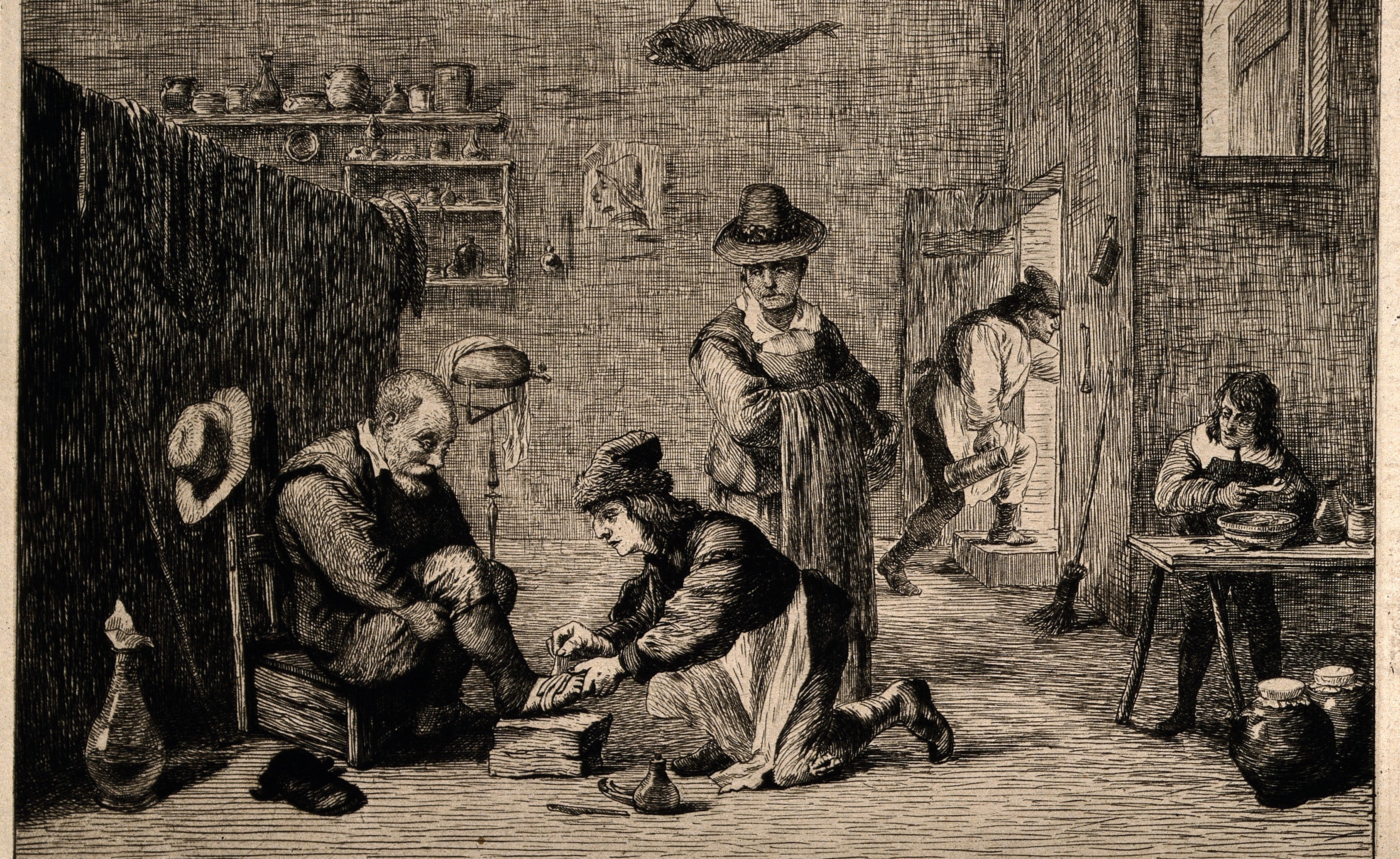 Historical image of a practitioner caring for an older man's foot