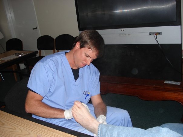 A foot care professional trimming a patient’s toenails