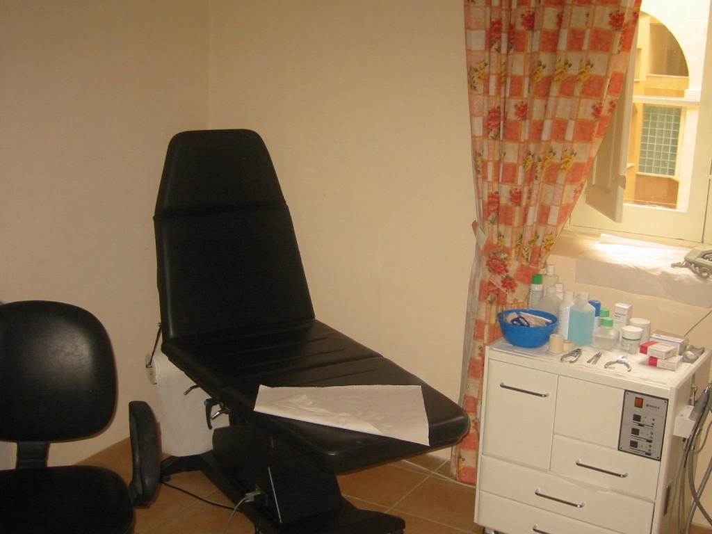 Podiatry treatment chair and foot care equipment in a clinical room