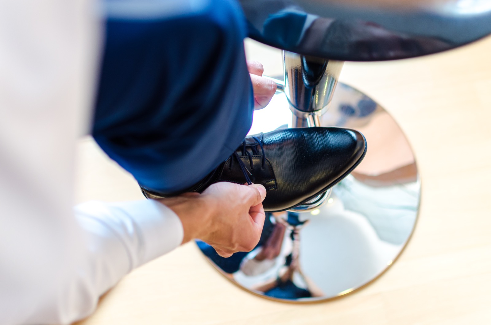Person putting on shoes before checking for toe pressure