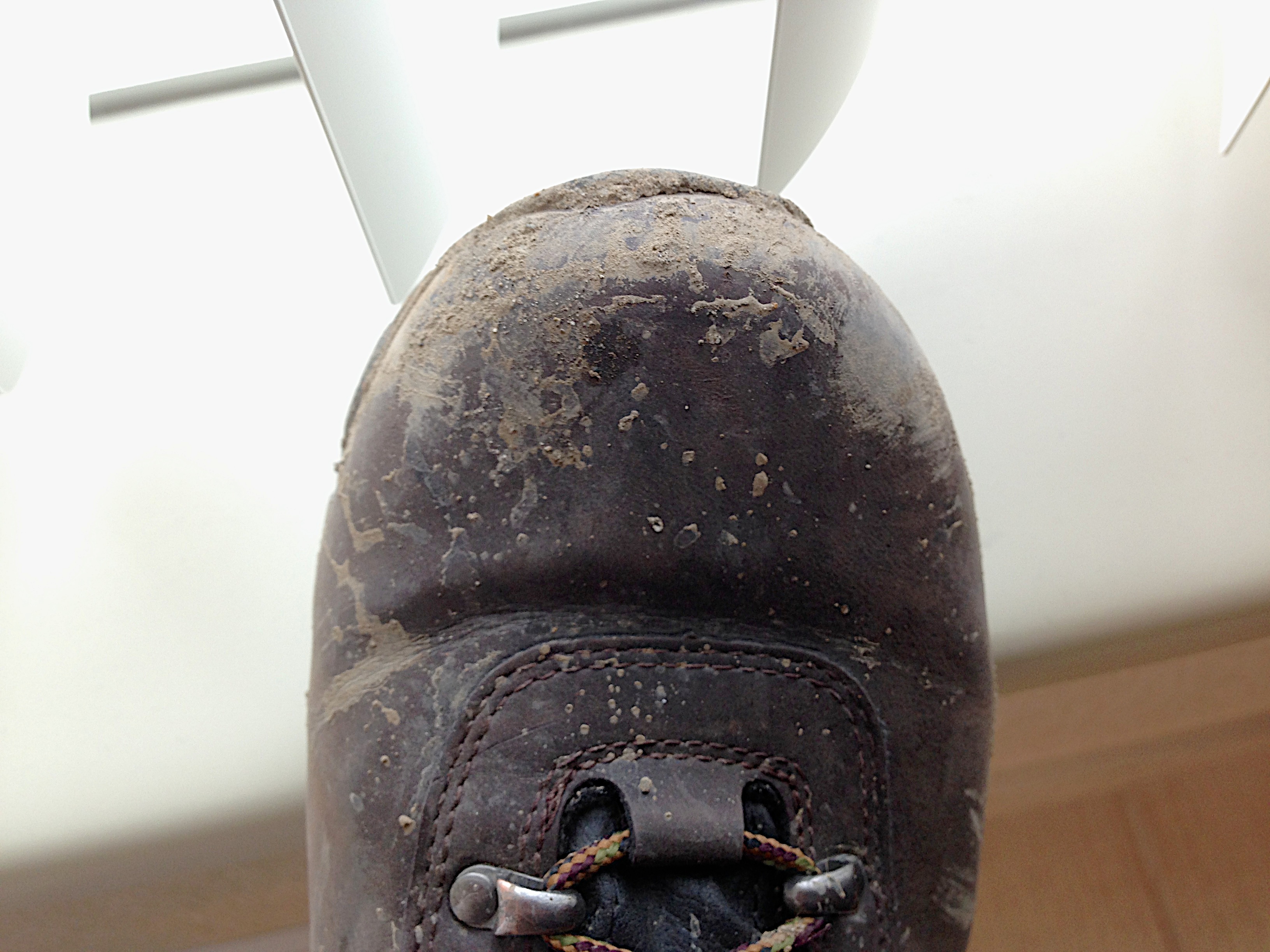 Close view of a worn walking shoe where repeated pressure can affect the toes and forefoot