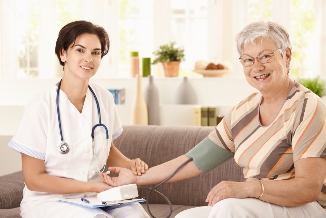 An older adult receiving care at home while family support is arranged around them