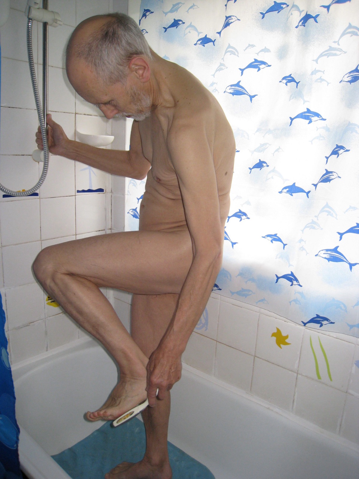A shower with a grab rail and mat for safer foot care