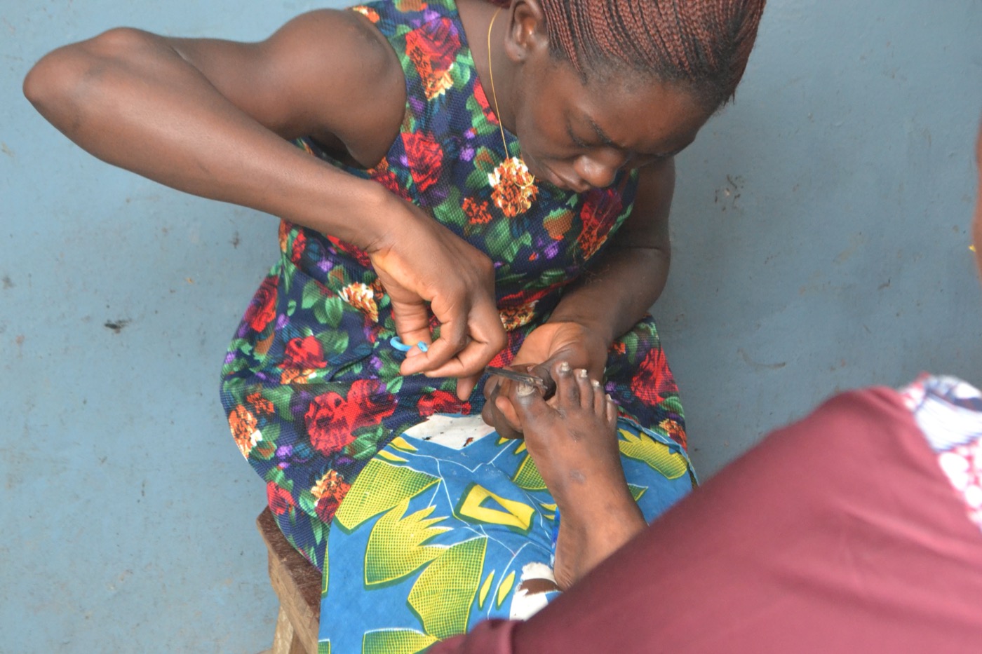 Foot care tools and treatment context used to show careful help with difficult toenails
