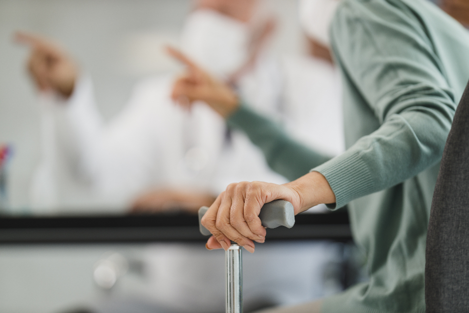 Older hands resting together used to show family support and preparation before home care