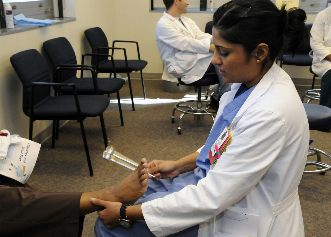 A clinician checking foot sensation during an appointment